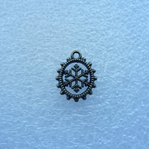 Breloque medaillon flocon de neige metal couleur bronze