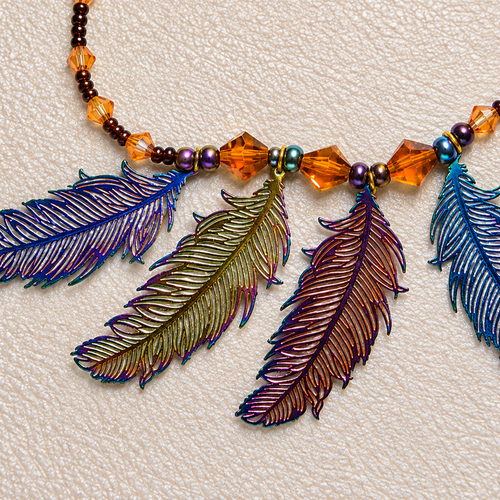 Collier artisanal bohème à 4 plumes irisées – cristal, verre et rocaille – acier inoxydable