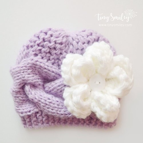 Bonnet bébé tricoté en violet avec une jolie fleur torsades