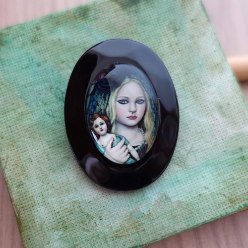 Broche forme ovale motif fillette à la poupée