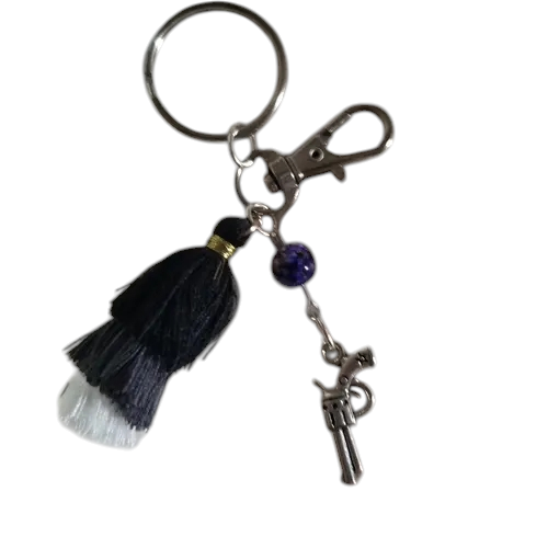Porte clé avec pompon noir, gris et blanc révolver