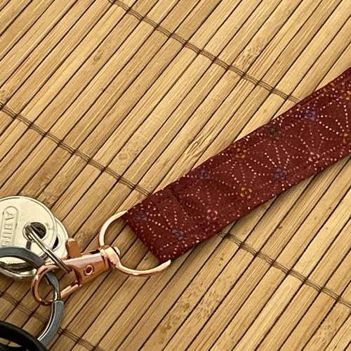 Porte-clés lanière bordeaux à petits motifs