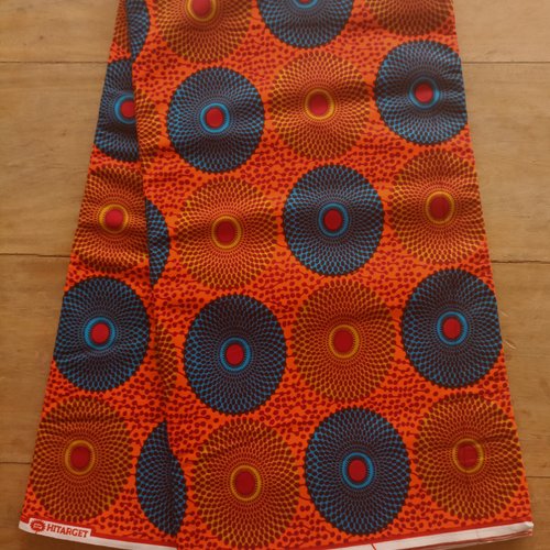 Tissu wax - par 50 centimètres - petits disques jaunes et bleus fond orange vif - 100% coton - tissu africain - pagne