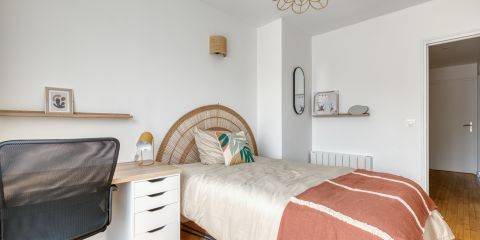 Chambre équipée d'un bureau et d'un dressing avec étagères, commode et tringle